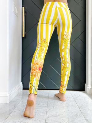 Bold yellow stripes and florals adorn these high waisted compression leggings